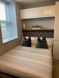 a bed with two pillows on it in a bedroom at Homely Beachside Apartment in Newquay Town Centre! in Newquay