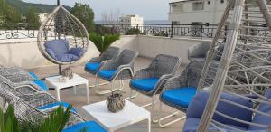 a group of chairs and swings on a balcony at Kristal Apartmani in Čanj