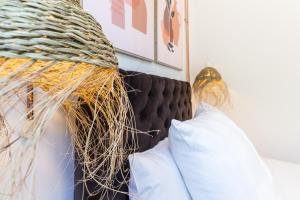 a bedroom with a bed with a bunch of pillows at @ rita'splace in Faro