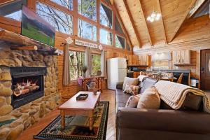 a living room with a couch and a fireplace at Rustic Retreat in Sevierville