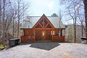 a log cabin in the middle of the woods at Rustic Retreat in Sevierville
