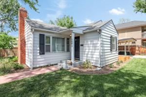 a small white house with a yard at Celebration Chalet! Quant, cozy, a few blocks from BSU and close to downtown Boise, Fireplace, 4 beds, and seating for 6 Pets Welcome! in Boise