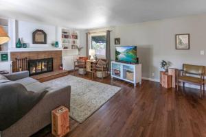 a living room with a couch and a fireplace at Celebration Chalet! Quant, cozy, a few blocks from BSU and close to downtown Boise, Fireplace, 4 beds, and seating for 6 Pets Welcome! in Boise