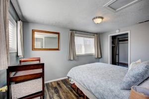 a bedroom with a bed and a mirror on the wall at Red Bench Cottage Ideal location near parks, trails, skiing, hiking, biking, shopping extended stays welcome in Boise