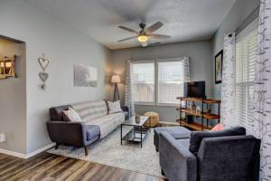 a living room with two couches and a ceiling fan at Red Bench Cottage Ideal location near parks, trails, skiing, hiking, biking, shopping extended stays welcome in Boise