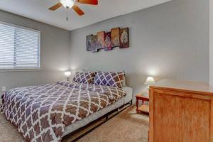 a bedroom with a bed and a ceiling fan at Luxe on Penn Family Friendly, Toddler amenities, baby proof with baby gate, toys, bath toys, cups and plates, Separate Workstation with Desk and Monitor, located in desirable SE Boise next to the Greenbelt and Boise River in Boise