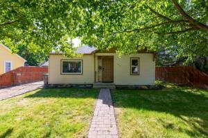 a small house with a yard with a fence at Home Sweet Idahome, feels like home with all the decor you wish you could afford King bed in master, fully fenced dog friendly yard, a few blocks from BSU and downtown Boise, Your perfect stay! in Boise