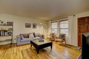 a living room with a couch and a table at Sunset Home perfect for extended stays with fully fenced in yard, designated office, two living rooms, located across from Boise Foothills and close to Bogus Basin in Boise's North End in Boise