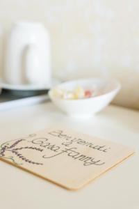 a menu on a table with a bowl of food at B&B Casa Fanny Riviera Del Conero in Loreto