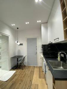 a kitchen with a sink and a table at Luxury Apartament in Blloku in front of Taiwan in Tirana