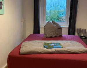 a bed in a room with a pillow on it at Osthafen III in Berlin