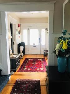 a living room with a door and a rug at Windsor Guest House in Vancouver