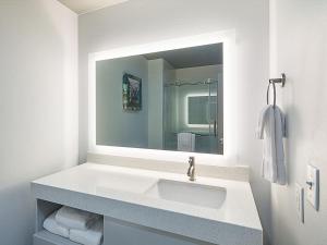 a bathroom with a sink and a mirror at Four Points by Sheraton Plano in Plano
