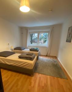 two beds in a room with a window at Osthafen IV in Berlin