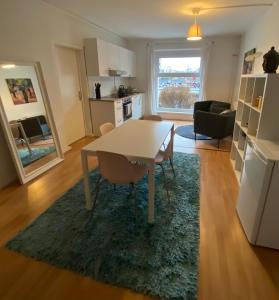 a kitchen and living room with a table and chairs at Osthafen IV in Berlin