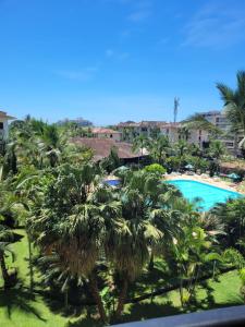 a view of the pool from the balcony of a resort at CONDOMINIO WEMBLEY TENIS in Ubatuba