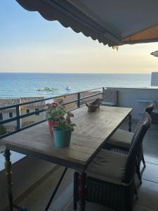 a table on a balcony with a view of the ocean at Daydream Seaview Deluxe Home 152 by New Era in Glyfada beach Corfu in Glyfada