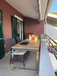 a table on a balcony with two potted plants at Daydream Seaview Deluxe Home 152 by New Era in Glyfada beach Corfu in Glyfada