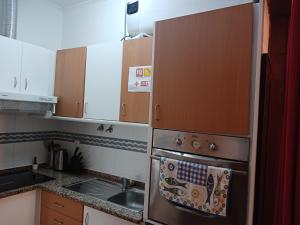 a kitchen with a dish towel hanging on the oven at Appartement Lisbonne Estrela in Lisbon