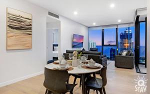 a dining room and living room with a table and chairs at 3 Bedroom Private Apartments at Casino - Q Stay in Gold Coast