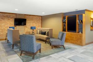 a living room with chairs and a couch and a tv at Best Western Natchitoches Inn in Natchitoches