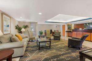 a living room with a couch and chairs and a table at SureStay Plus Hotel by Best Western Scottsdale North in Scottsdale