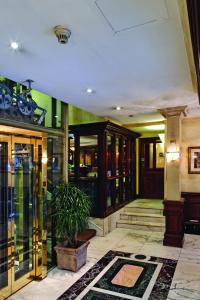 a lobby with glass doors and a potted plant at Rochester Hotel by Blue Orchid in London