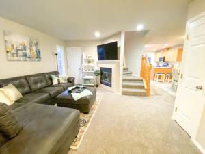a living room with a couch and a fireplace at The Getaway SE Boise Condo Across the street from Greenbelt, Bown Crossing and Boise River 3BD 3Bath, 4 beds! Lovely, Homey, Dining table seats 6 in Boise
