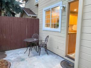 a patio with a table and chairs and a fence at The Getaway SE Boise Condo Across the street from Greenbelt, Bown Crossing and Boise River 3BD 3Bath, 4 beds! Lovely, Homey, Dining table seats 6 in Boise