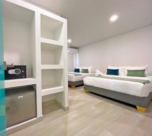 a bedroom with two beds and a tv in it at Zaba Beach House in San Andrés