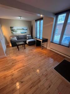 a living room with a couch and a table at Appartement Condo dans le vieux Québec in Quebec City