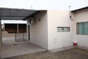 a garage with awning on the side of a building at Departamentos Mora in General Alvear