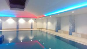 a large swimming pool with a pool at Spacious Apartment with Swimming Pool, Gym and Sauna WWA40 in Warsaw
