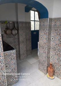 a kitchen with a blue door and a vase at DAR TAZROUT in Tangier +92 photos