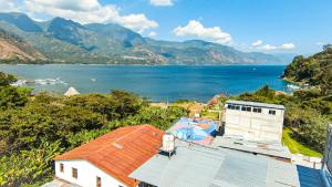 a house with a view of a body of water at Casa Argentina in San Juan La Laguna