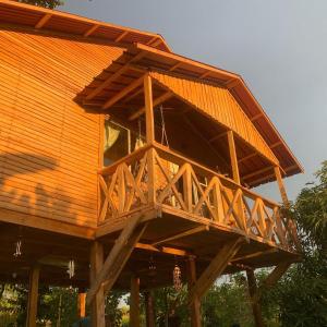 a large wooden house with a wooden roof at Ecovillalova in Camú