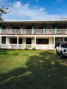 a house with a car parked in front of it at Jackson Guest House in Corn Island
