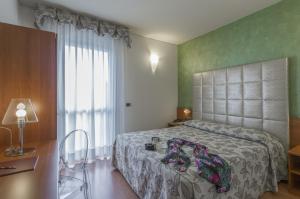 Postel nebo postele na pokoji v ubytování Hotel Doge