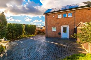 a brick house with solar panels on the roof at Contractors and Groups! Free Parking! Large Off Street Driveway! Ideal for Long Stays! in Birmingham