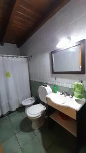 un baño con inodoro y lavabo en Cabañas Akasha, en San Rafael