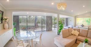 a living room with a table and a couch at Noosa North Shore Retreat in Noosa North Shore
