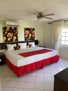 een slaapkamer met een groot bed en een rode deken bij 1 bedroom Penthouse Suite 63 at Mystic Ridge Resort in Ocho Rios