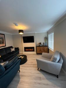 a living room with two couches and a fireplace at No. 8 Ceide Spris Self Catering House in Killarney