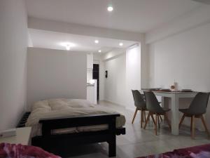 a bedroom with a bed and a table and chairs at Mirador La Viña in Salta