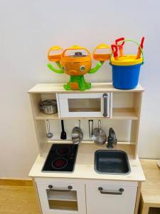 a toy kitchen with a stove and a sink at bebe angpang 2 in Seogwipo