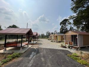 a row of camping huts on a gravel road at Laman Cottage @ Brisu, Melaka in Malacca