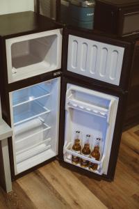an open refrigerator with bottles of beer in it at The Free Spirit Retreat in Newaygo
