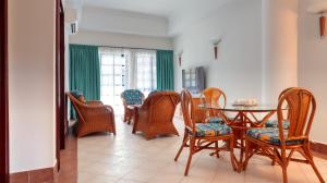 uma sala de jantar com mesa e cadeiras em Long Sands Port Dickson em Porto Dickson