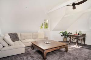 a living room with a couch and a table at The Barn in Kangaroo Valley