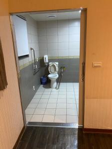 a bathroom with a toilet in a stall at Zhongshan Boutique Hotel in Kaohsiung +17 photos